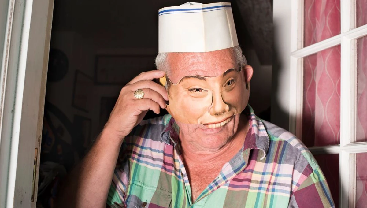 Stuart in his doorway wearing a mask